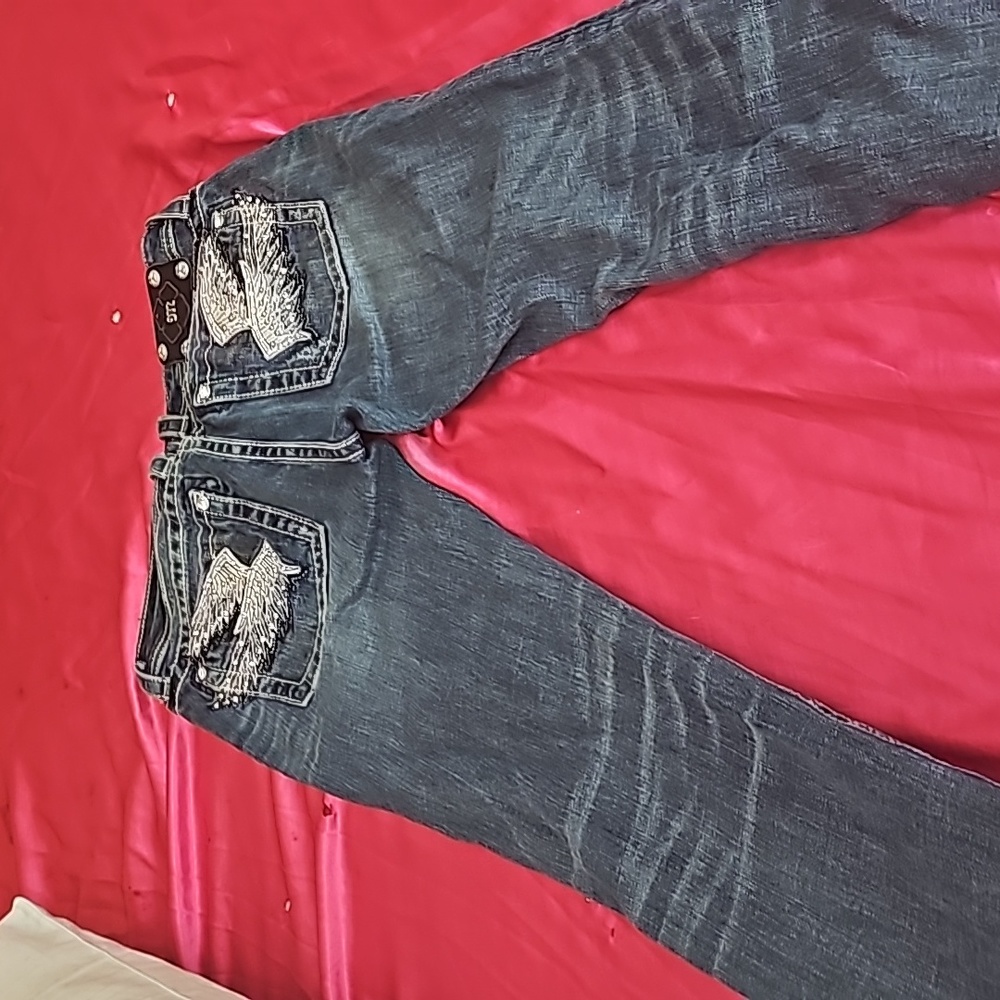 Miss me, jeans with angel wing on back.